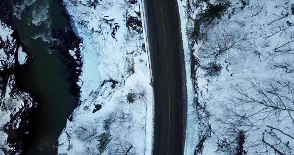 Aerial View of a Mountain Road Covered in Snow alt