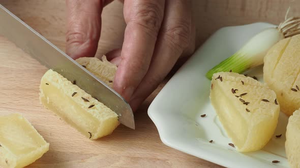 Hands cutting traditional Czech cheese. Stinky cheese. Aromatic delicacy. Dairy products. 