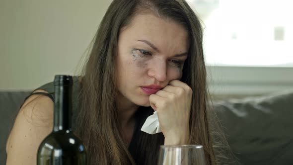 Depressed Young Woman Crying a Victim of Domestic Violence or Abuse Tries to Relieve Suffering with