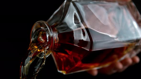 Super Slow Motion Shot of Pouring Whiskey From Bottle at 1000Fps with Camera Movement alt