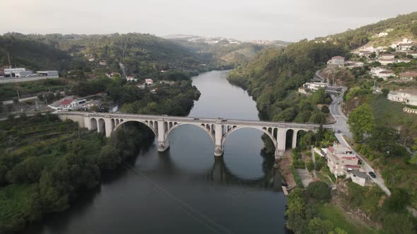 Aerial forward view of an amazing Douro valley with its bridge. Entre Os Rios. Portugal