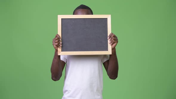 Young African Man Showing Blackboard alt