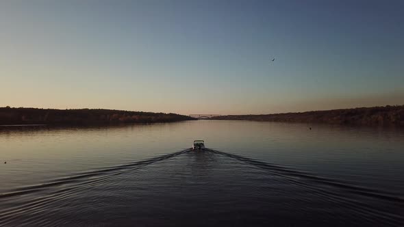  Motor Boat Floating on the River at Sunset