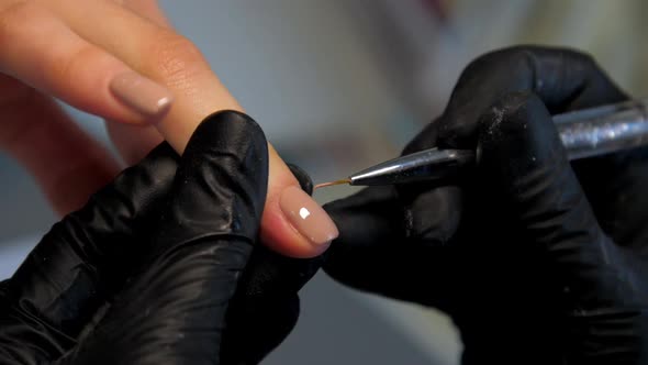Professional Manicurist Applies Gel on Visitor Fingernail alt