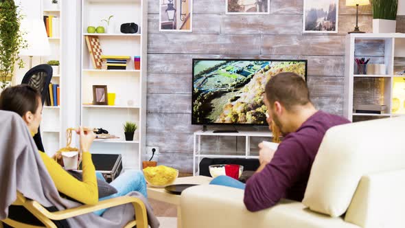 Back View of Boyfriend and Girlfriend Sitting on Chairs alt