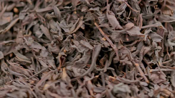 Looped Spinning Dry Black Tea Full Frame Closeup Background alt