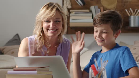 Happy family at home, smiling mother with son use computer