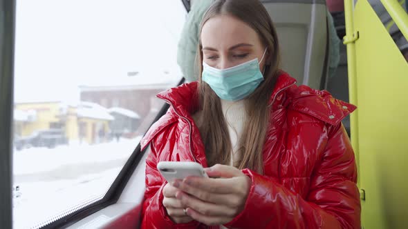 Woman Checks Mail in Phone in Trolleybus on Way to Work alt