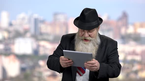 Funny Businessman Playing Game on Tablet Pc alt