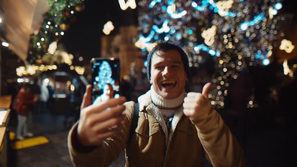 Happy and Smiling Young Man Show Thumb UP Call Home From Street on Video Call