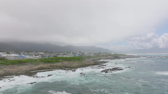 Slide and Pan Shot of Waves Crashing on Rocks at Sea Coast alt