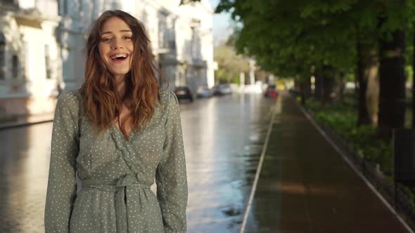 Portrait of Stylish Caucasian Woman 20s Wearing Summer Dress Laughing While Walking Through Empty alt