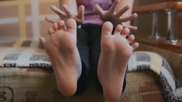 Little Teenager Girl Plays with Her Toes