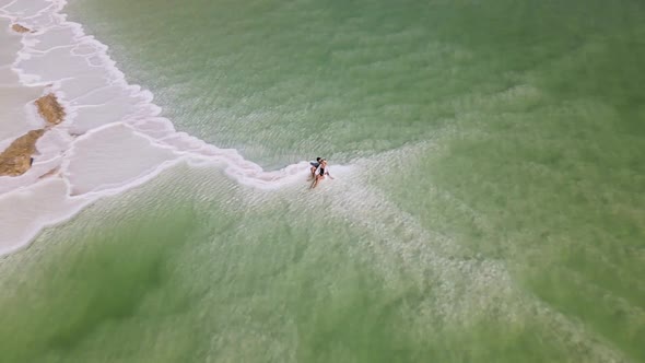 Loving Couple is Resting on the Dead Sea