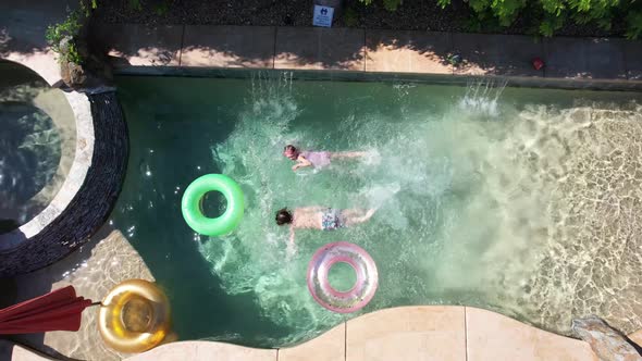 Kids Swimming In Pool Aerial View