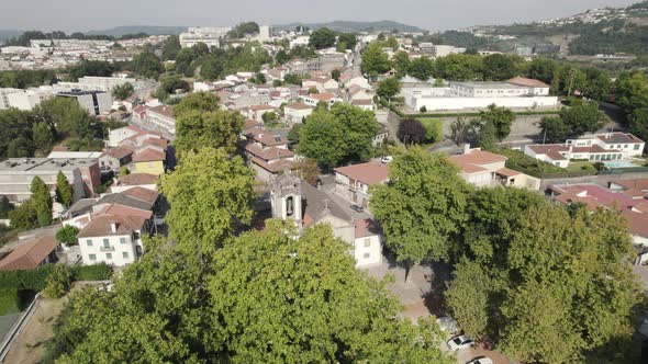 Drone flight over tree lane reveals Church of St. Damasus; Guimaraes