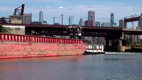 tug boat pushing barge under bridge city skyline 4k alt