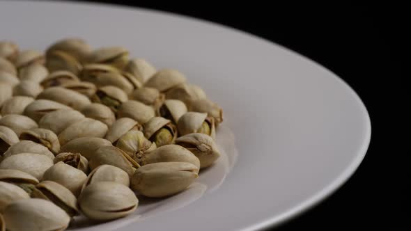 Cinematic, rotating shot of pistachios on a white surface - PISTACHIOS 021 alt