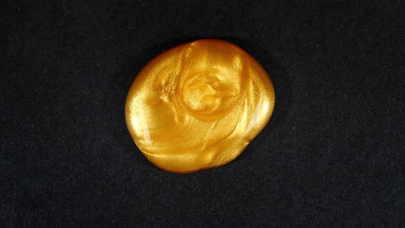 Abstract Brushstrokes of Gold Paint Brush Applied Isolated on a Black Background alt