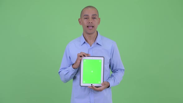 Happy Bald Multi Ethnic Businessman Talking While Showing Digital Tablet alt