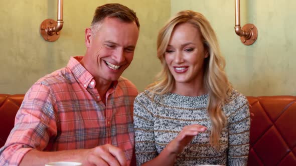 Couple taking selfie on mobile phone in restaurant 4k alt