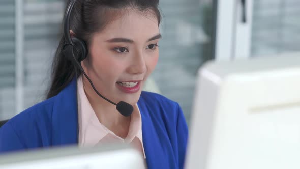 Businesswoman Wearing Headset Working Actively in Office alt
