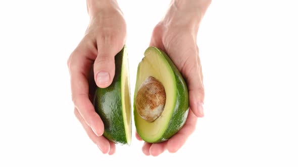 Female hands hold avocado, close up alt