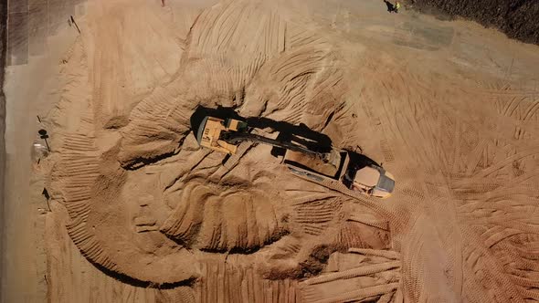 Top Down View of Excavator Working in Construction Site alt