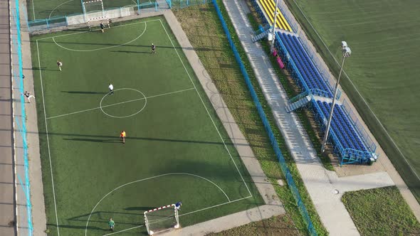 Top View of a Sports Football Field with Players Playing Football