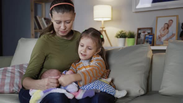 Mother Woman And Newborn Baby And Elder Daughter And Dog