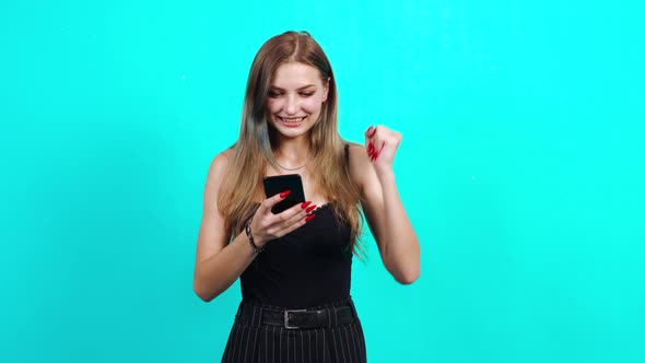 The Surprised Teenager Receives a Message on the Phone. Happy with the News Received. alt