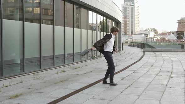 A successful and in a good mood businessman goes to his favorite job and listens to music. alt