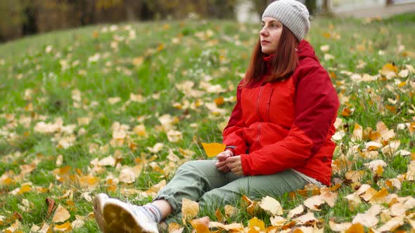 Beautiful Caucasian Girl in Warm Clothes Enjoying Autumn Time in the Park