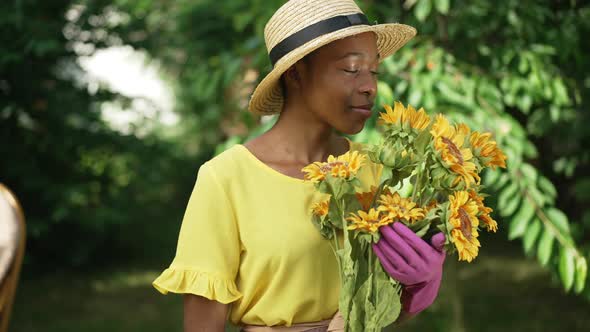 Medium Shot Slim African American Beautiful Woman with Bouquet of Sunflower Posing in Sunshine alt