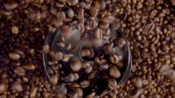 Closeup Coffee Seeds Pouring in Grinder Top View alt