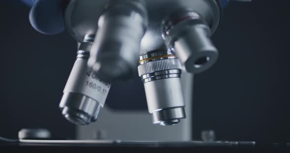 Sample Slide and Microscope with Metal Lens at Laboratory alt