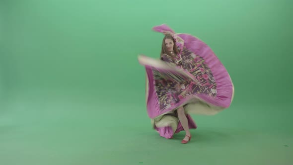 Beautiful Girl In Balkan Pink Dress Dancing Gypsy Folk Dance Isolated On Green Screen