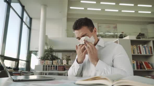 Sick Businessman with Temperature Works in Office and Wipes His Nose with a Napkin, Latinos Man alt