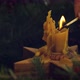 Hand lighting up candle in christmas wreath close up on rustic wooden table - VideoHive Item for Sale