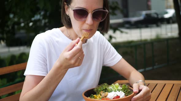 Woman Eating Poke Salad on Summer Cafe in Park