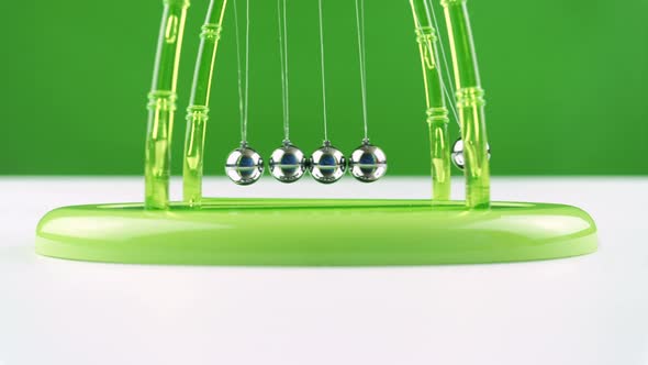 Green Pendulum Balls Newton On White Green Background. 1.