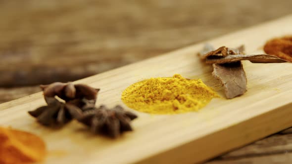 Various spices on wooden tray 4k alt