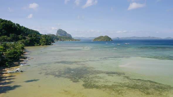El Nido Palawan Island Philippines Aerial Drone View of Boats Anchored in the Bay with Clear Emerald alt
