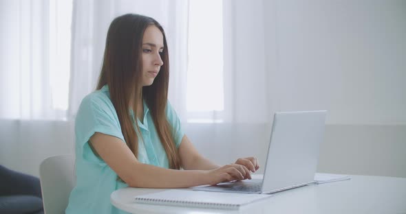 Businesswoman With Laptop In Her Office At The Desk, Working. Business Woman Works on Laptop on alt