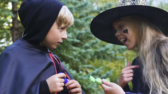 Children in Halloween Costumes Arguing Who Will Collect More Candies alt