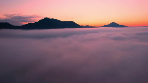 4K Aerial video Beautiful sunrise above dense clouds and fog in the morning alt