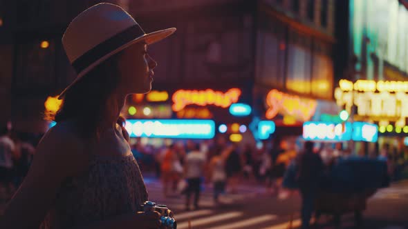 Young photographer with a retro camera in Times Square alt