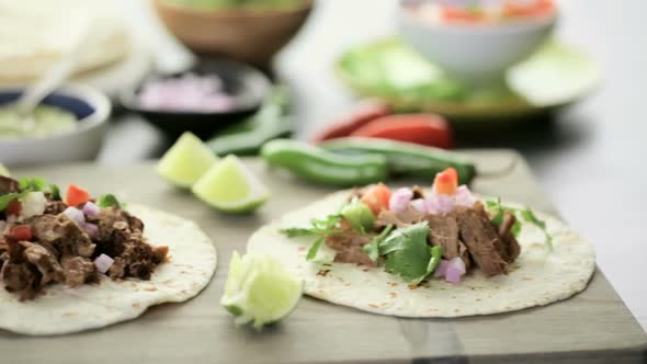 Pulled pork carnitas with pico de gallo on a flour tortilla. alt
