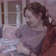 Senior couple embracing grandchild on sofa at home, multi generation togetherness - VideoHive Item for Sale