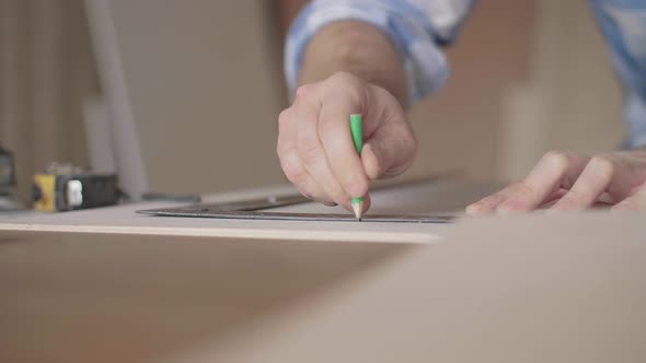 Carpenter Makes Pencil Markings on the Blank with the Help of a Ruler